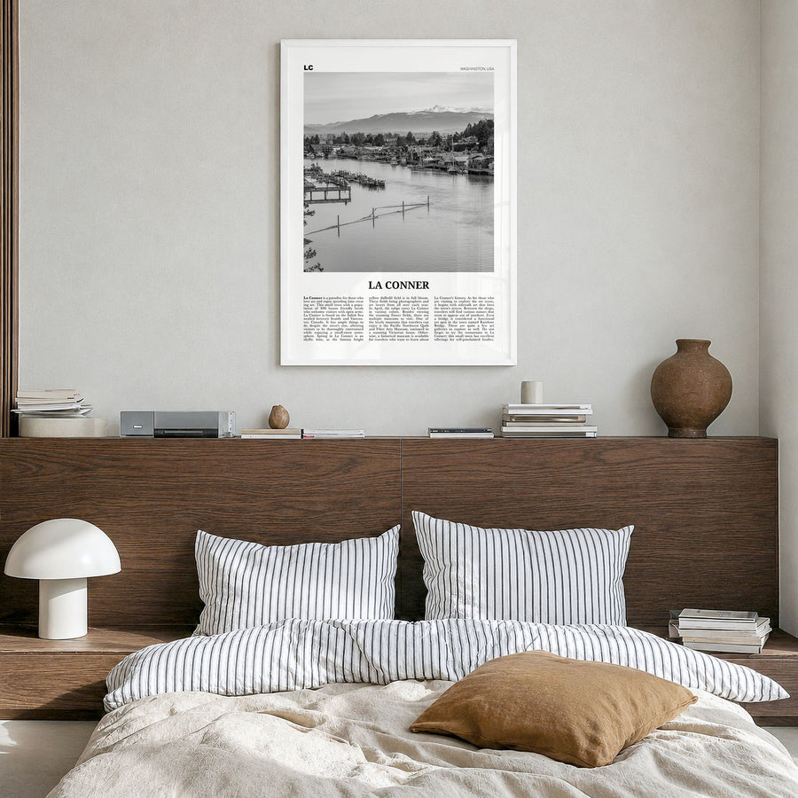 La Conner Newspaper Poster in a white wood frame, hanging in a bedroom