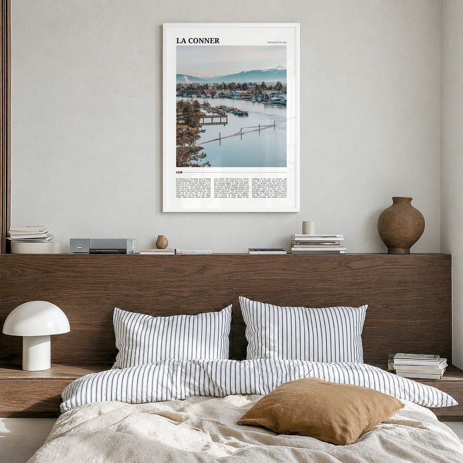 La Conner Travel Poster in a white wood frame, hanging in a bedroom