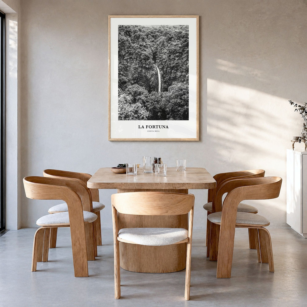 La Fortuna Classic Poster in a natural wood frame, hanging in a dining room