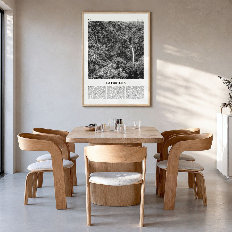 La Fortuna Newspaper Poster in a natural wood frame, hanging in a dining room