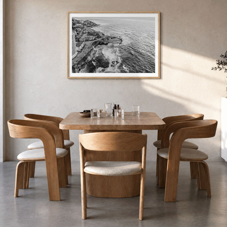 La Jolla Photo Poster in a natural wood frame, hanging in a dining room, white border