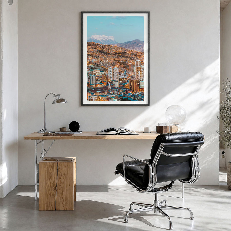 La Paz Photo Poster in a black wood frame, hanging in a bright home office, white border
