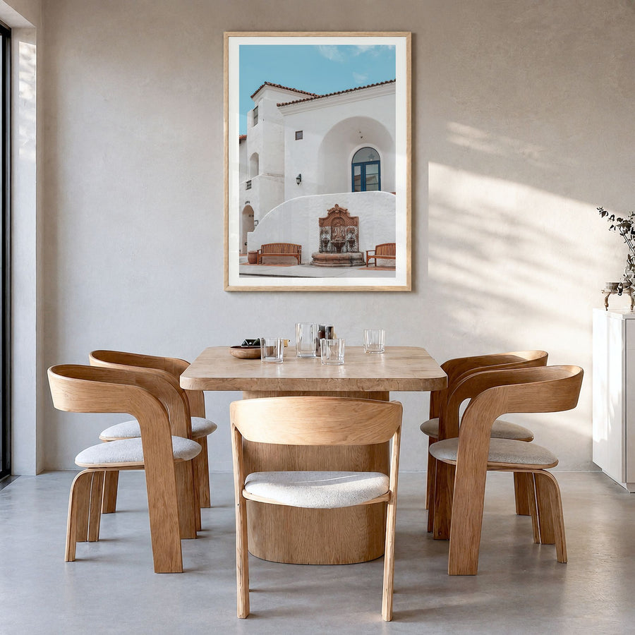La Quinta Photo Poster in a natural wood frame, hanging in a dining room, white border