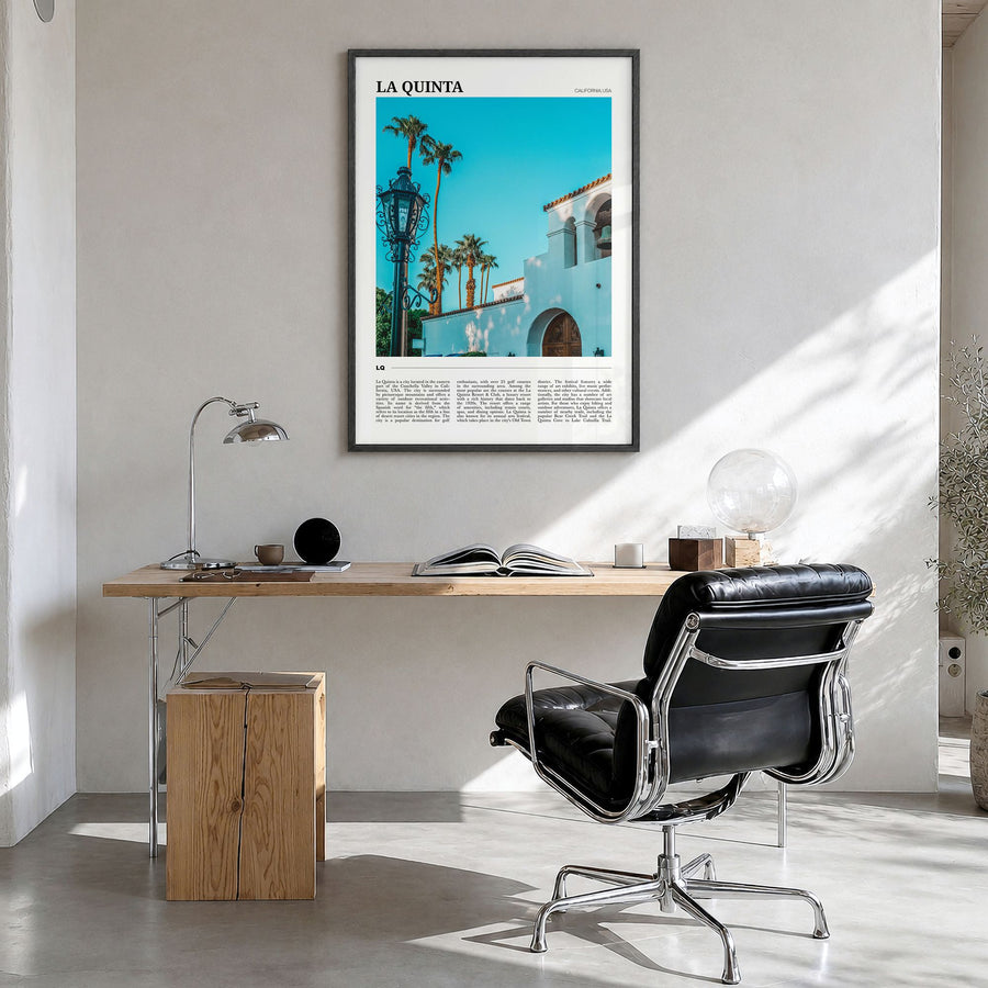 La Quinta Travel Poster in a black wood frame, hanging in a bright home office
