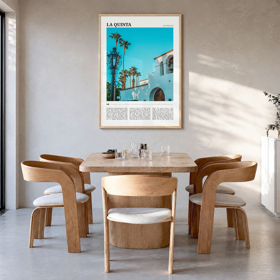 La Quinta Travel Poster in a natural wood frame, hanging in a dining room