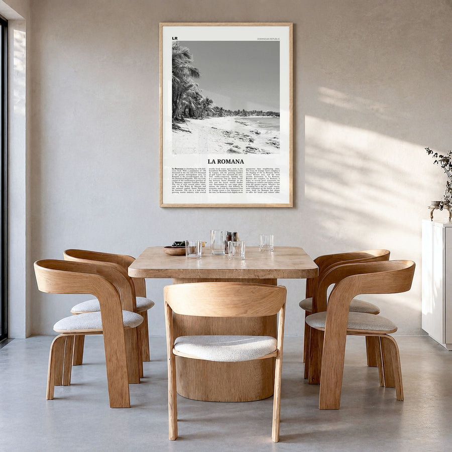 La Romana Newspaper Poster in a natural wood frame, hanging in a dining room
