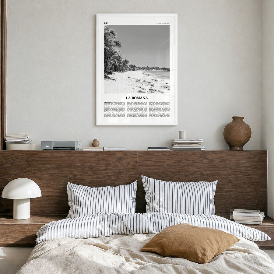 La Romana Newspaper Poster in a white wood frame, hanging in a bedroom