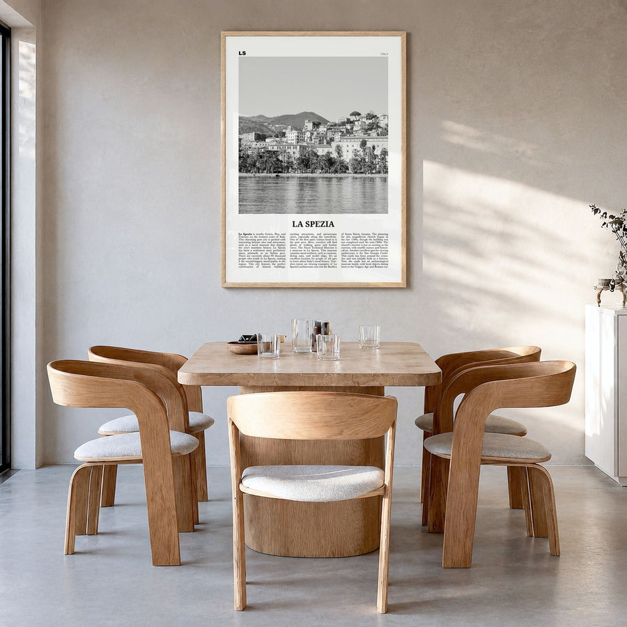 La Spezia Newspaper Poster in a natural wood frame, hanging in a dining room
