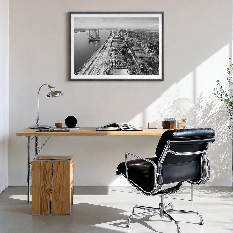 Lagos, Nigeria Photo Poster in a black wood frame, hanging in a bright home office, white border