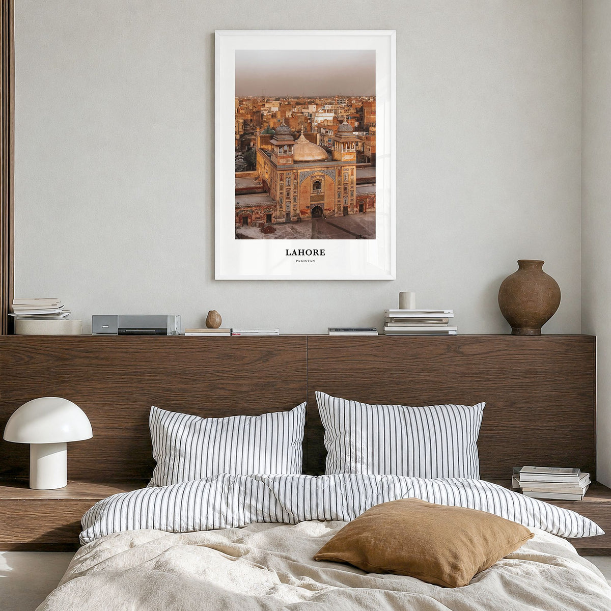 Lahore Classic Poster in a white wood frame, hanging in a bedroom