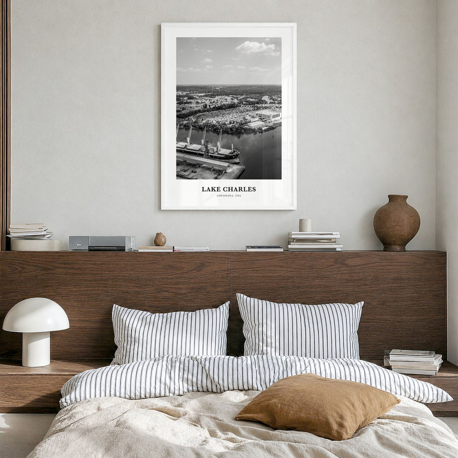 Lake Charles Classic Poster in a white wood frame, hanging in a bedroom