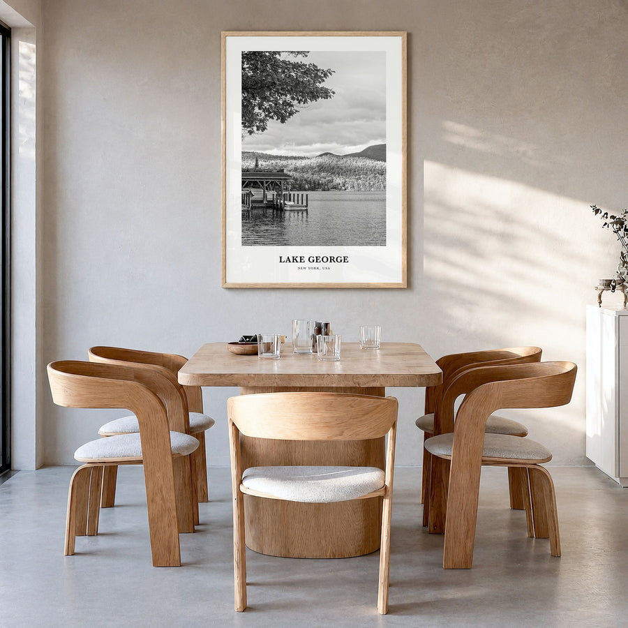 Lake George Classic Poster in a natural wood frame, hanging in a dining room