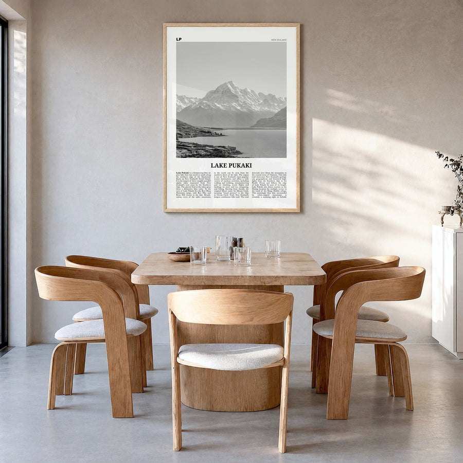 Lake Pukaki Newspaper Poster in a natural wood frame, hanging in a dining room