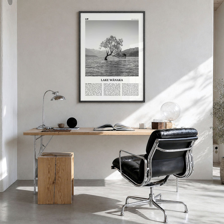 Lake Wānaka Newspaper Poster in a black wood frame, hanging in a bright home office