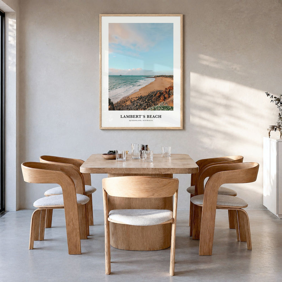 Lamberts Beach Classic Poster in a natural wood frame, hanging in a dining room
