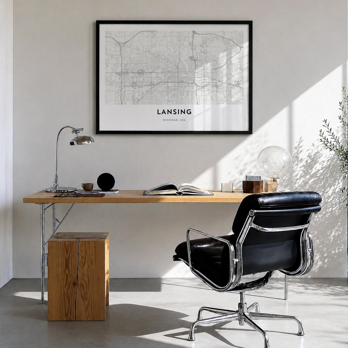 Lansing black & white map poster of Michigan, USA – horizontal wall art in black wood frame, hanging on wall