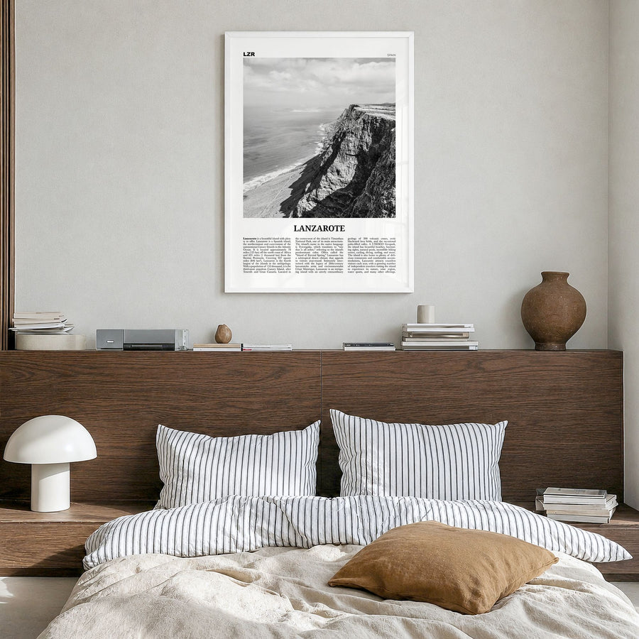Lanzarote Newspaper Poster in a white wood frame, hanging in a bedroom