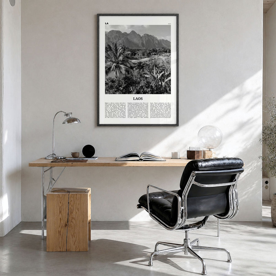 Laos Newspaper No 2 Poster in a black wood frame, hanging in a bright home office