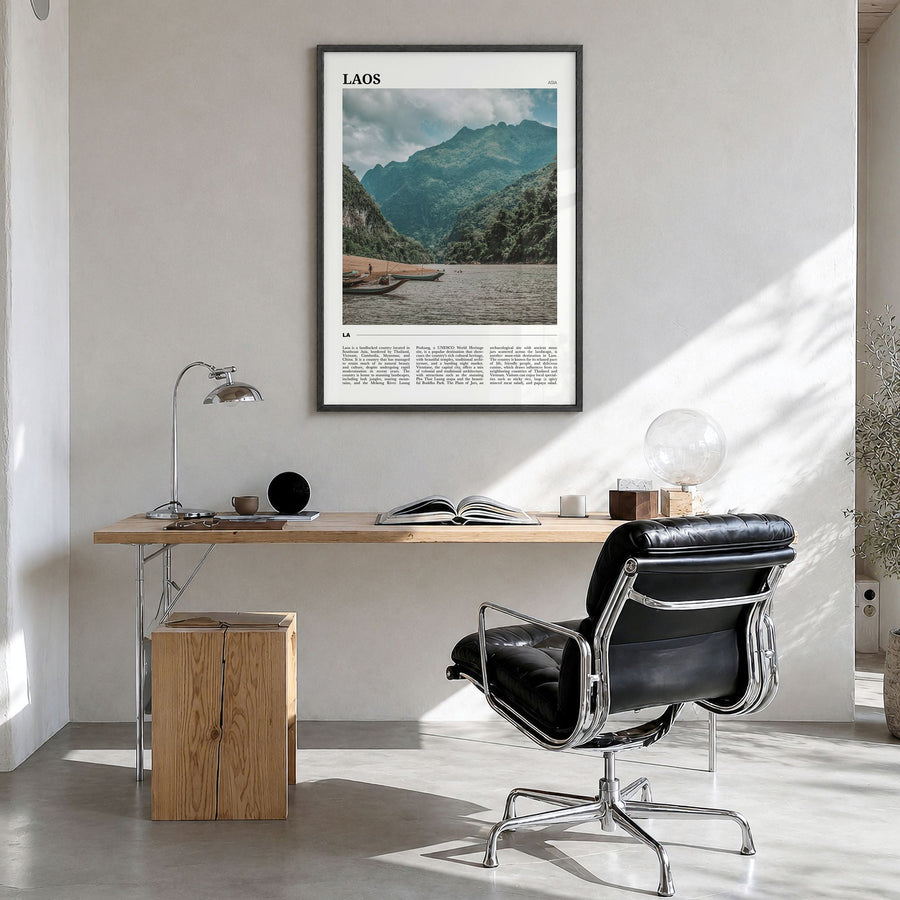 Laos Travel Poster in a black wood frame, hanging in a bright home office