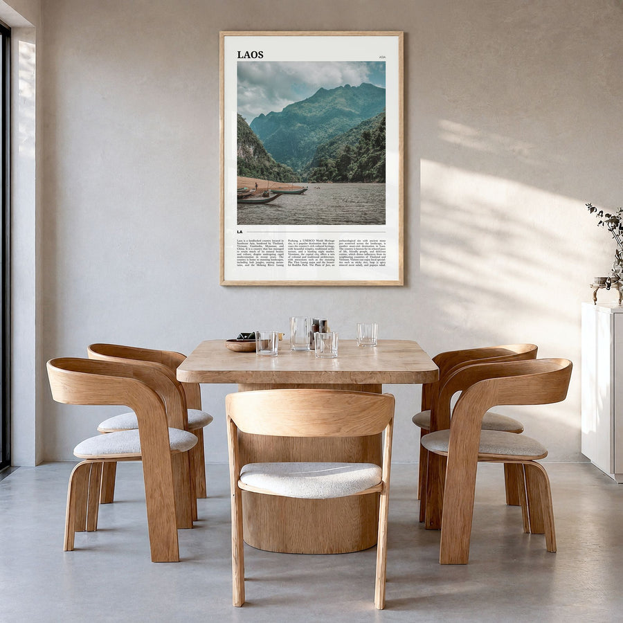 Laos Travel Poster in a natural wood frame, hanging in a dining room