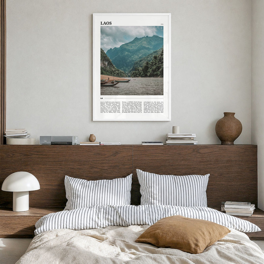 Laos Travel Poster in a white wood frame, hanging in a bedroom