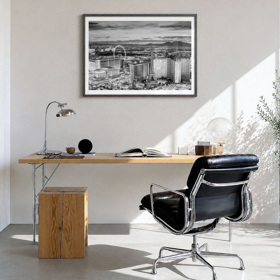 Las Vegas Photo Poster in a black wood frame, hanging in a bright home office, white border