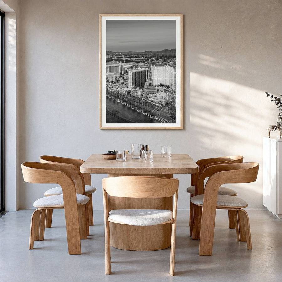 Las Vegas Photo Poster in a natural wood frame, hanging in a dining room, white border