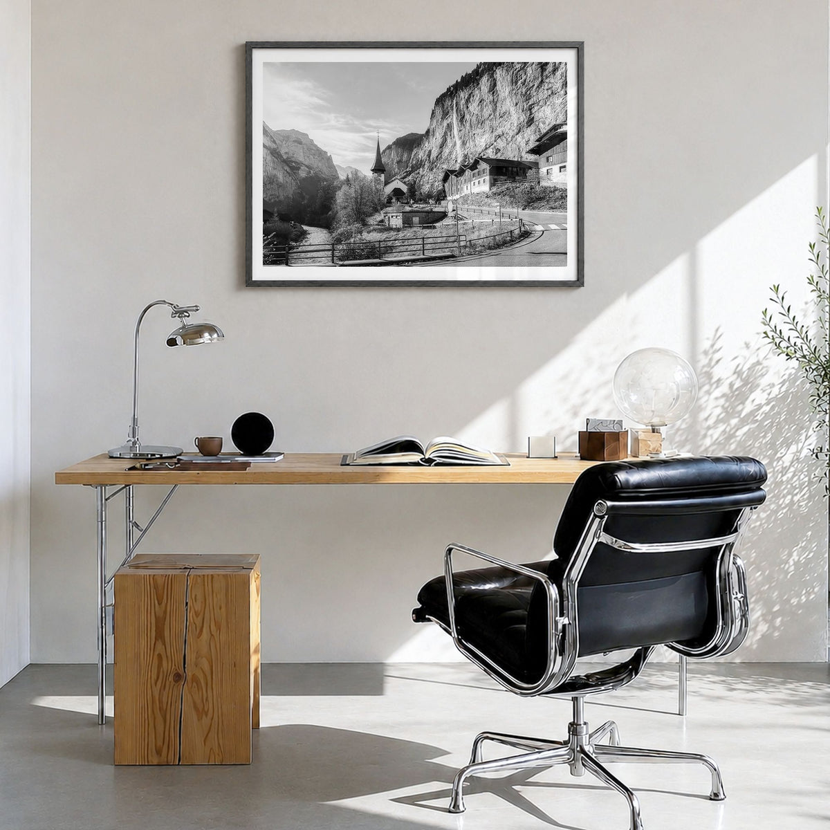 Lauterbrunnen Photo Poster in a black wood frame, hanging in a bright home office, white border