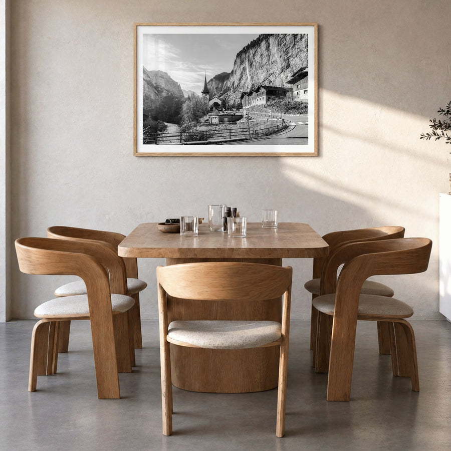 Lauterbrunnen Photo Poster in a natural wood frame, hanging in a dining room, white border
