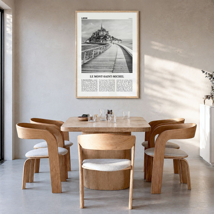 Le Mont-Saint-Michel Newspaper Poster in a natural wood frame, hanging in a dining room