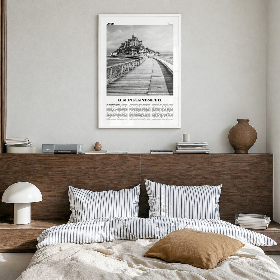 Le Mont-Saint-Michel Newspaper Poster in a white wood frame, hanging in a bedroom
