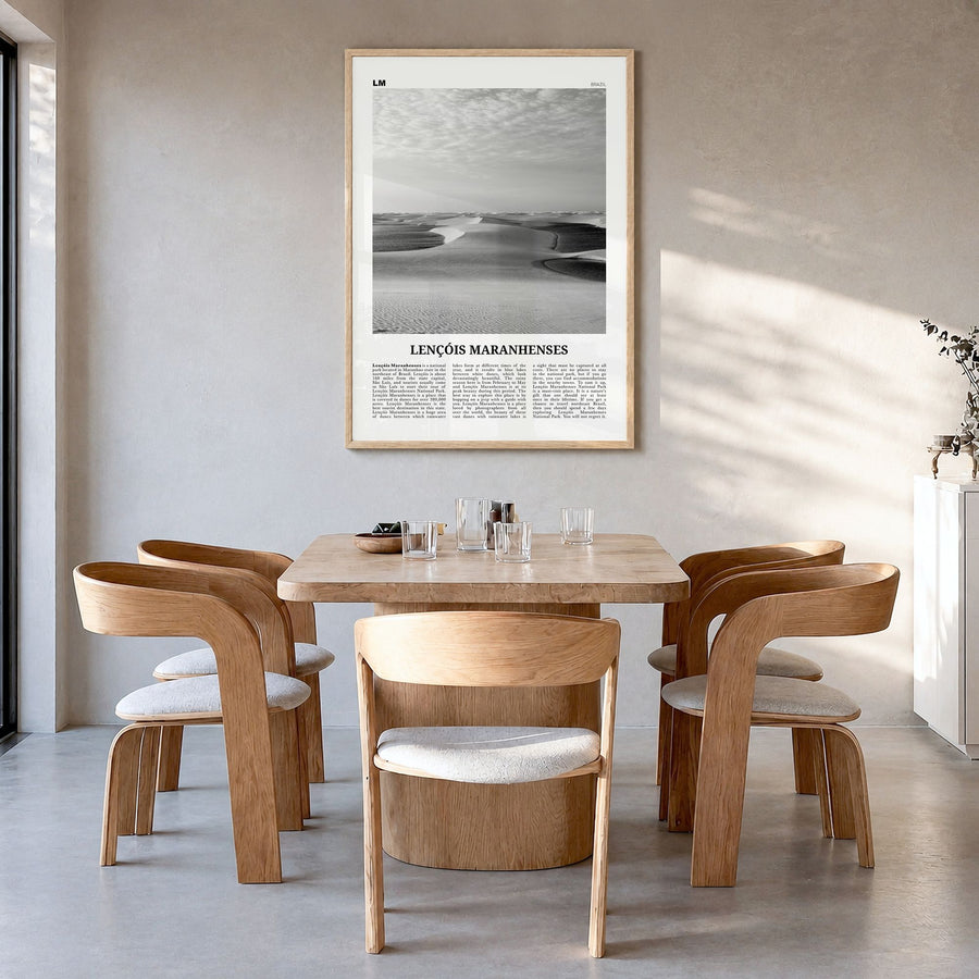 Lençóis Maranhenses Newspaper Poster in a natural wood frame, hanging in a dining room