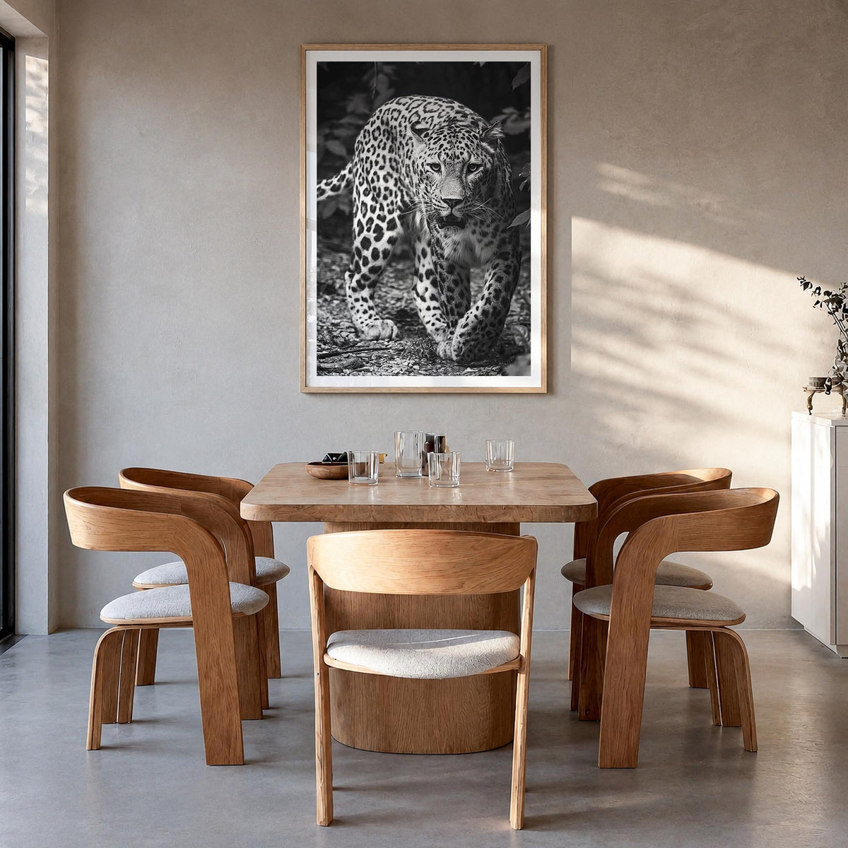 Leopard no. 1 black & white photo poster – vertical wall art in natural wood frame with white border, hanging on wall