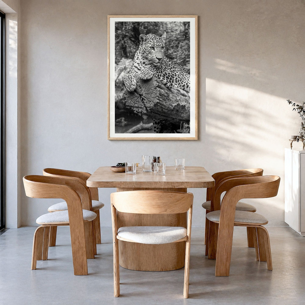 Leopard Photo No 2 Poster in a natural wood frame, hanging in a dining room, white border