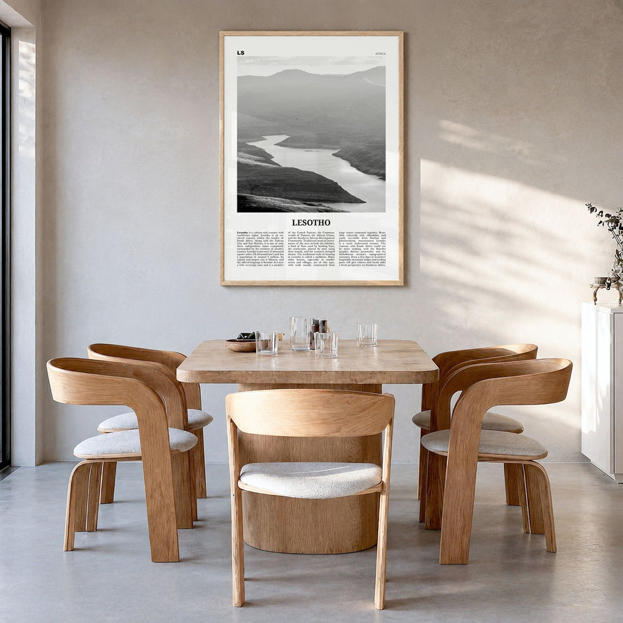Lesotho Newspaper Poster in a natural wood frame, hanging in a dining room