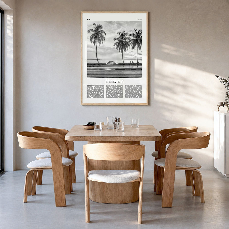 Libreville Newspaper Poster in a natural wood frame, hanging in a dining room