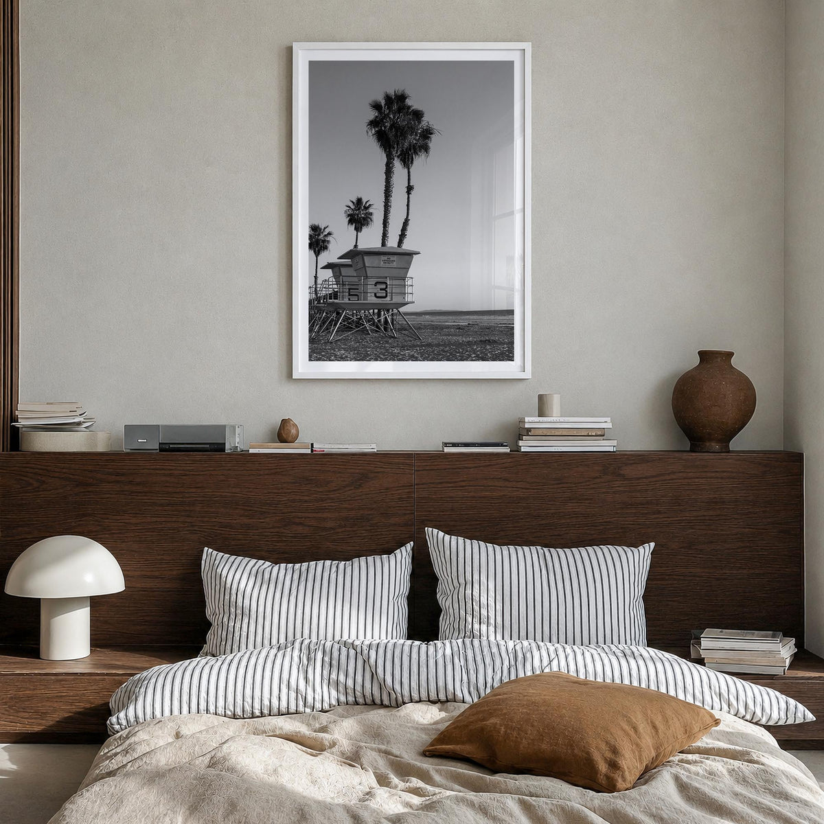 Lifeguard Stand no. 2 black & white photo poster – vertical wall art in white wood frame with white border, hanging on wall