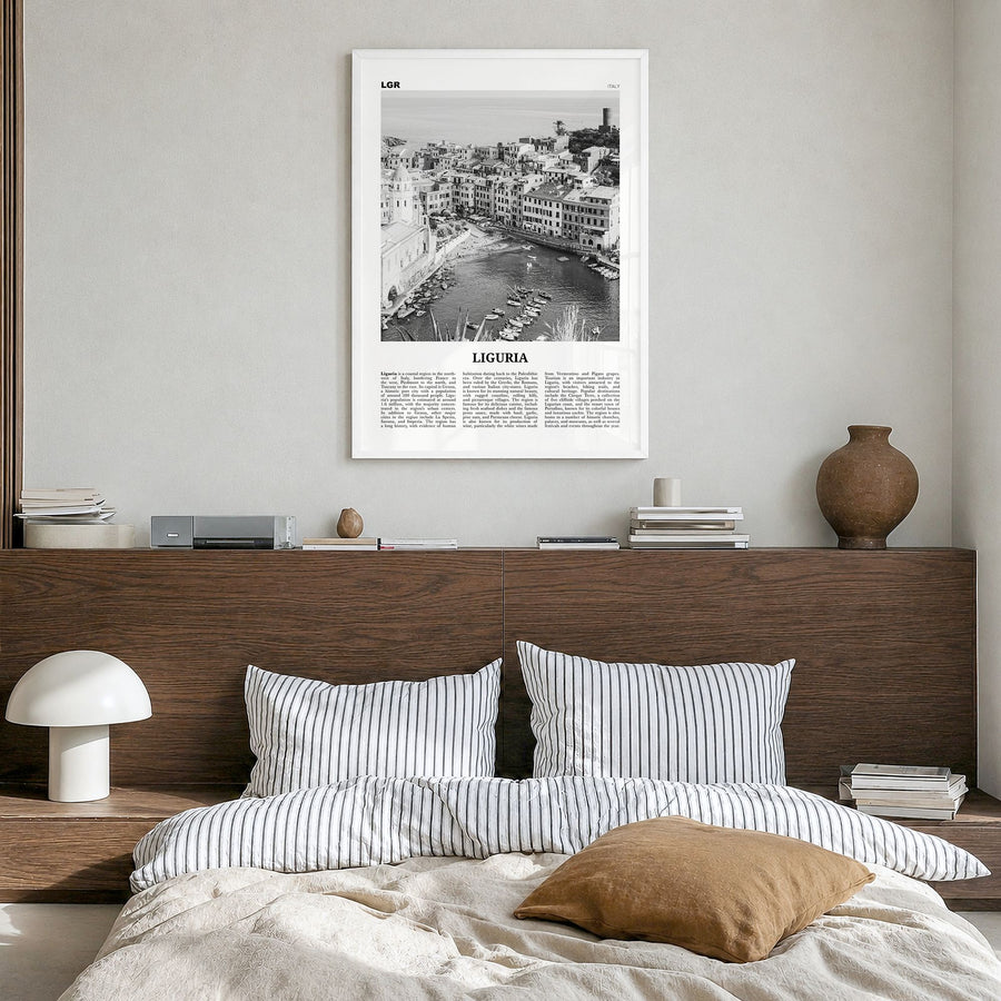 Liguria Newspaper Poster in a white wood frame, hanging in a bedroom