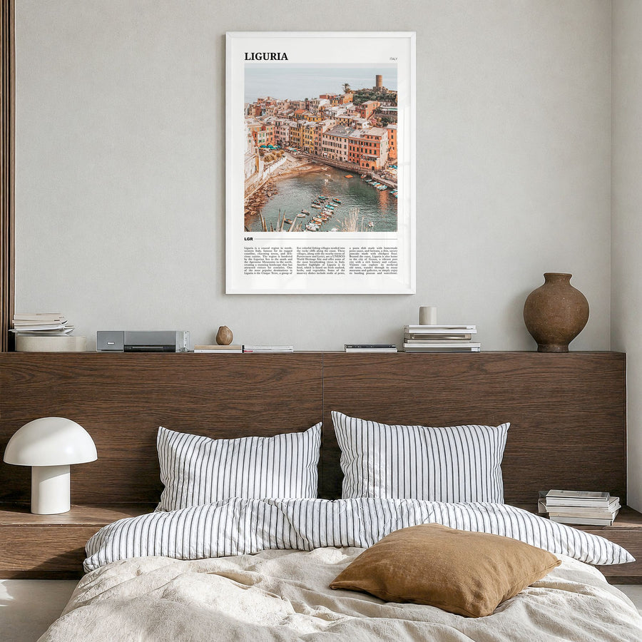 Liguria Travel Poster in a white wood frame, hanging in a bedroom