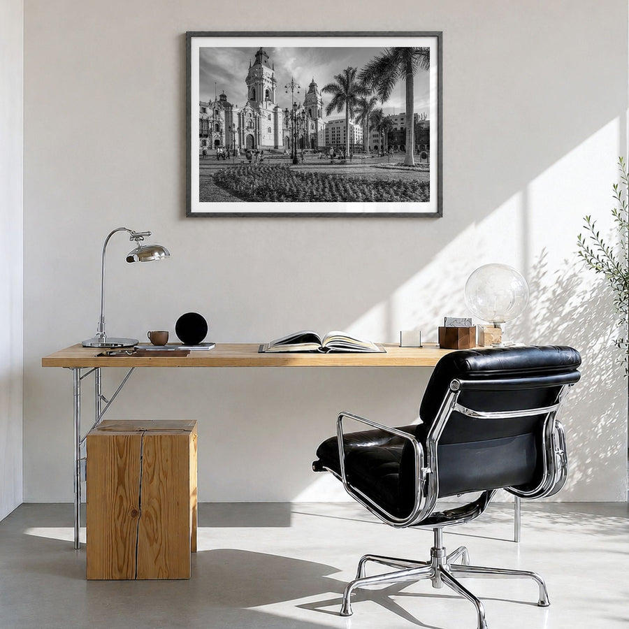 Lima Photo Poster in a black wood frame, hanging in a bright home office, white border