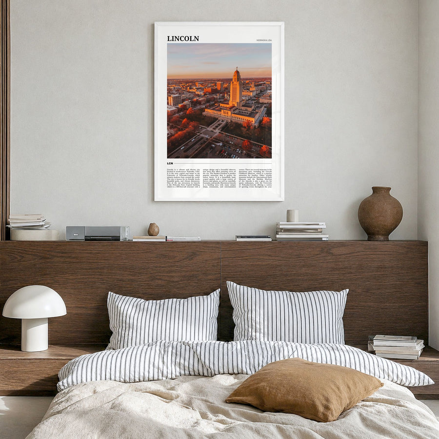 Lincoln Travel Poster in a white wood frame, hanging in a bedroom