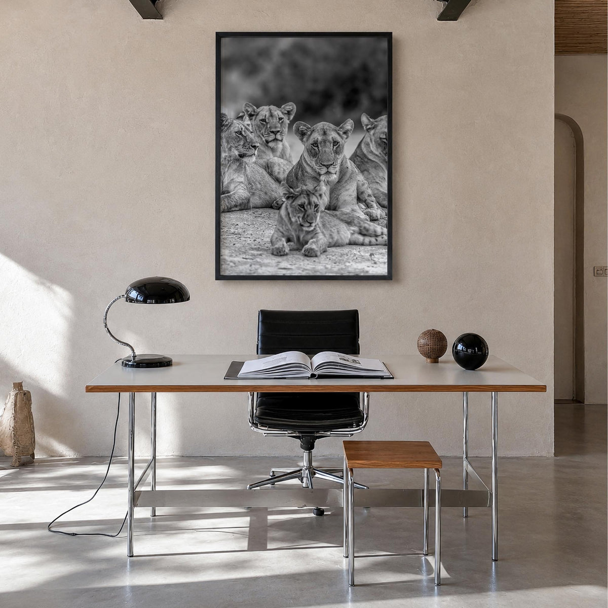 Lion no. 3 black & white photo poster – vertical wall art in black wood frame, hanging on wall