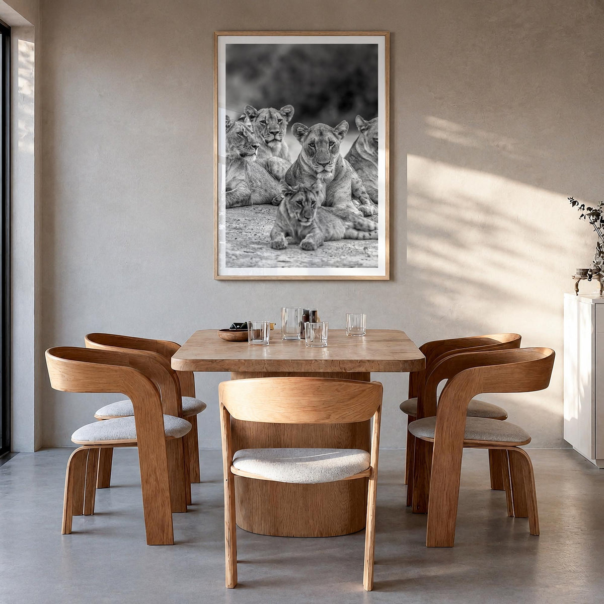 Lion no. 3 black & white photo poster – vertical wall art in natural wood frame with white border, hanging on wall