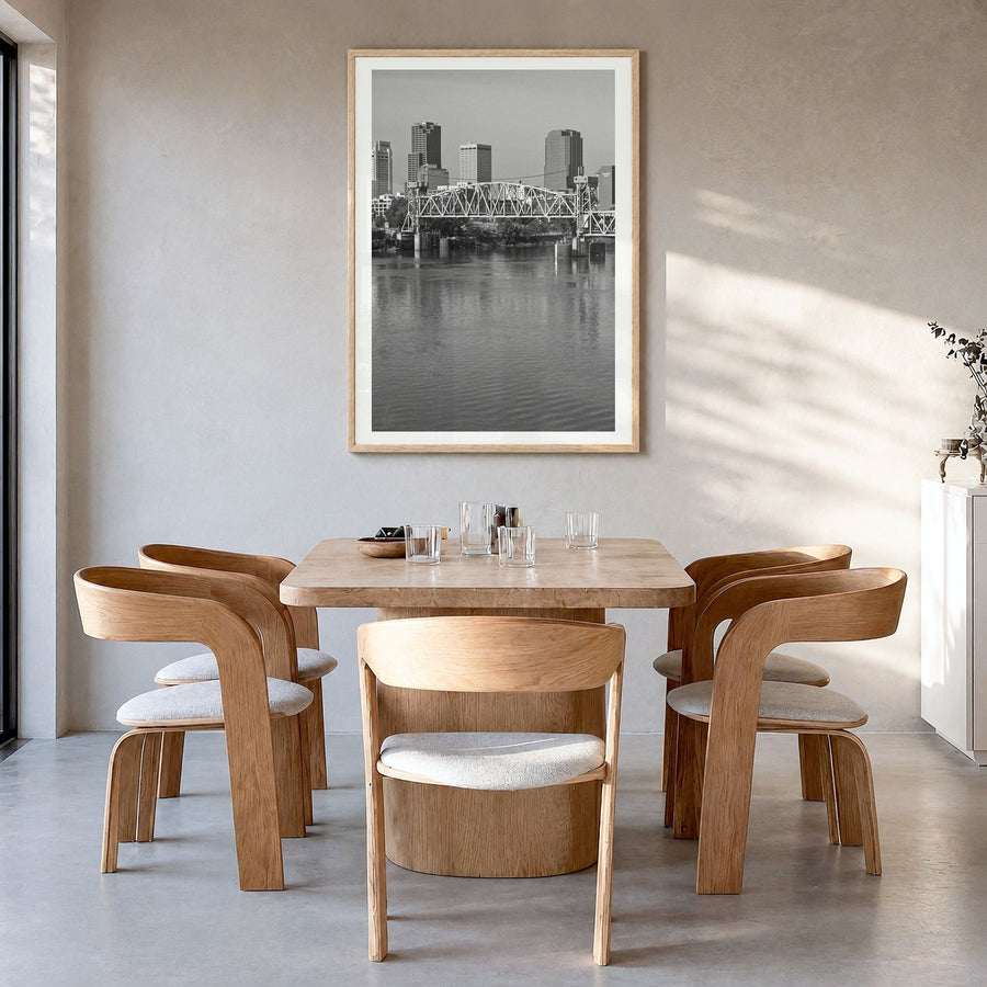 Little Rock Photo Poster in a natural wood frame, hanging in a dining room, white border