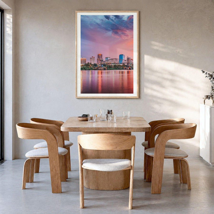 Little Rock Photo Poster in a natural wood frame, hanging in a dining room, white border