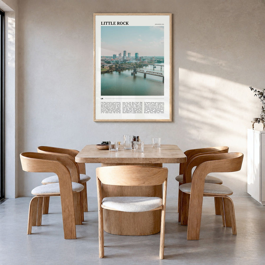 Little Rock Travel Poster in a natural wood frame, hanging in a dining room