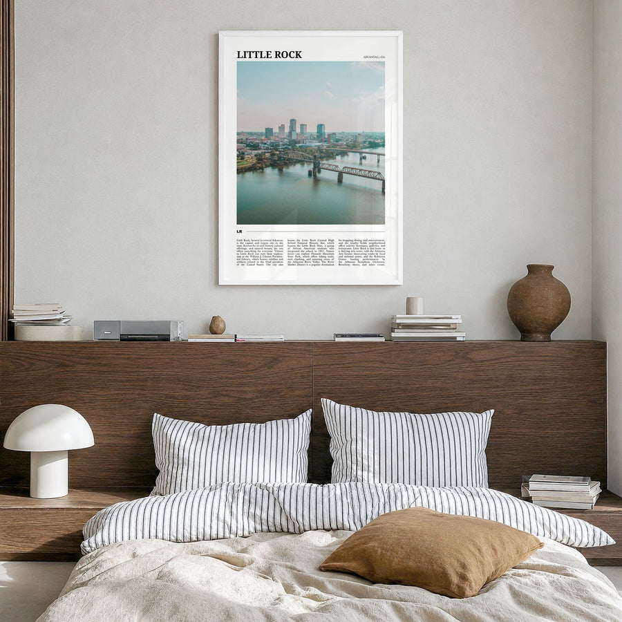 Little Rock Travel Poster in a white wood frame, hanging in a bedroom