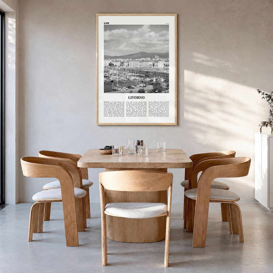 Livorno Newspaper Poster in a natural wood frame, hanging in a dining room