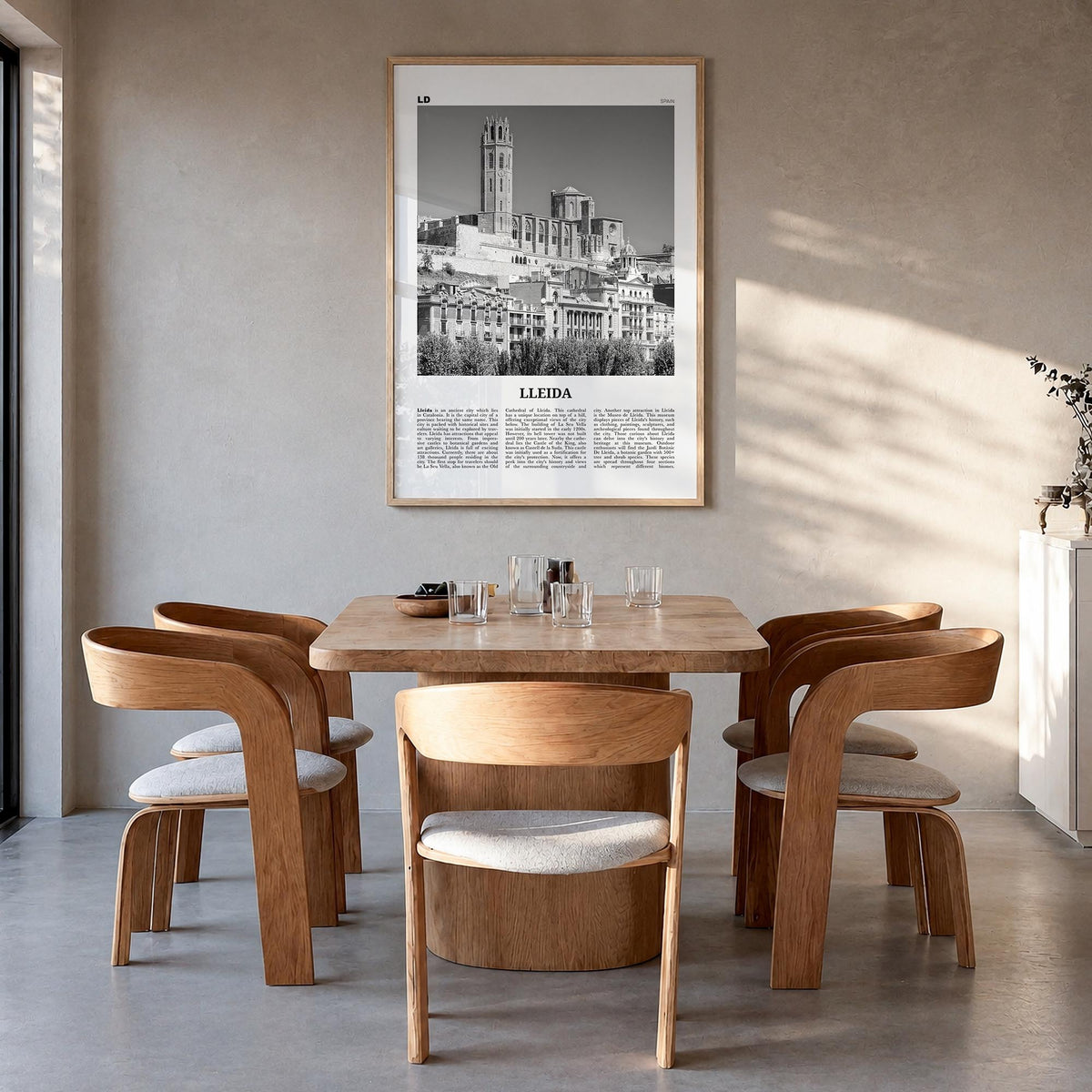 Lleida black & white newspaper poster of Spain – vertical wall art in natural wood frame, hanging on wall