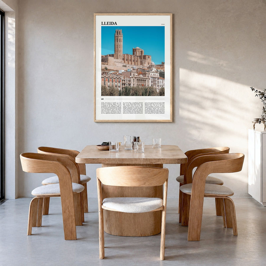 Lleida Travel Poster in a natural wood frame, hanging in a dining room
